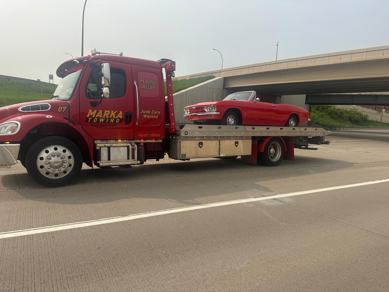 Marka Towing Unit 07 — Red Freightliner flatbed on the highway